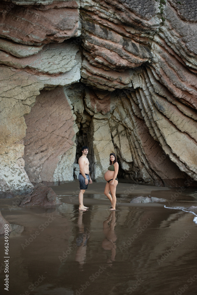 pregnant couple on the beach