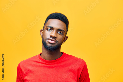 Happy young African American gen z guy isolated on beige background. Smiling hipster ethnic teen student  cool curly ethnic generation z teenager fashion model standing looking at camera  portrait.