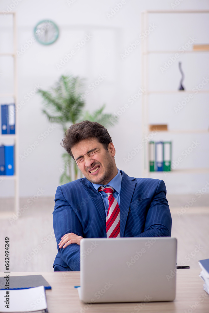 Young male employee working in the office Young male employee working in the office