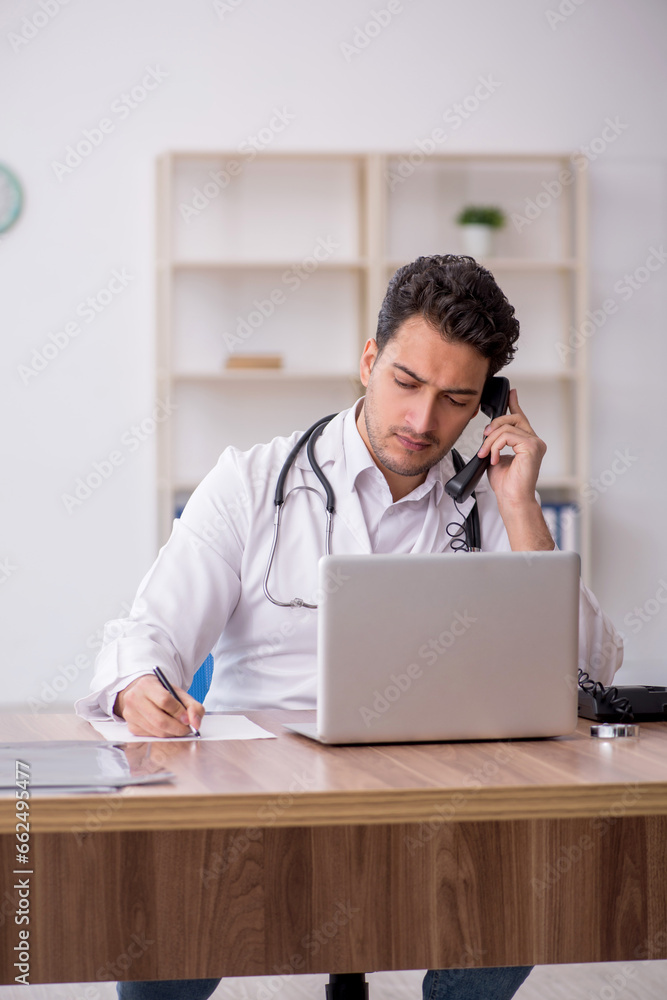 Young male doctor in telemedicine concept Young male doctor in telemedicine concept