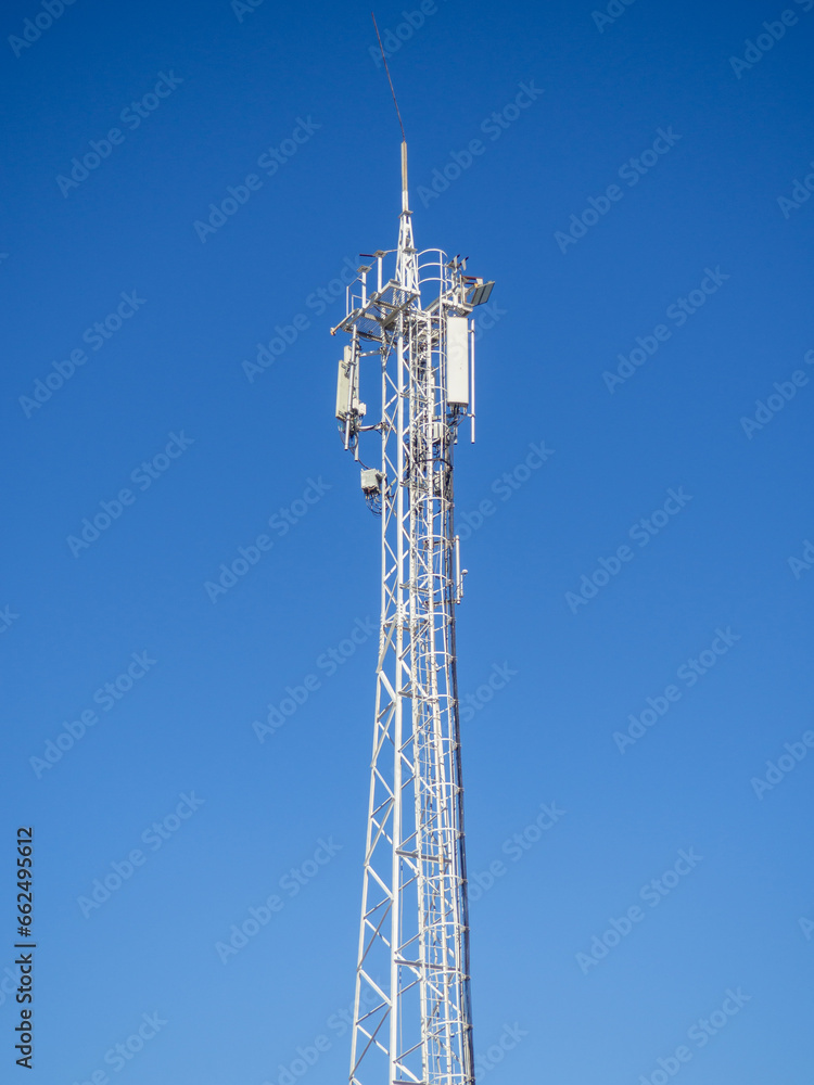 Internet and cell phone tower. Internet communications. Communication concept. White tower against the sky.