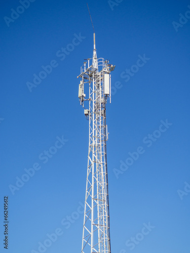 Internet and cell phone tower. Internet communications. Communication concept. White tower against the sky.