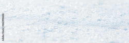 Snow surface close-up. Winter background with snow texture. Shallow depth of field and blur. Wide panoramic texture for background and design. © Andrei Stepanov
