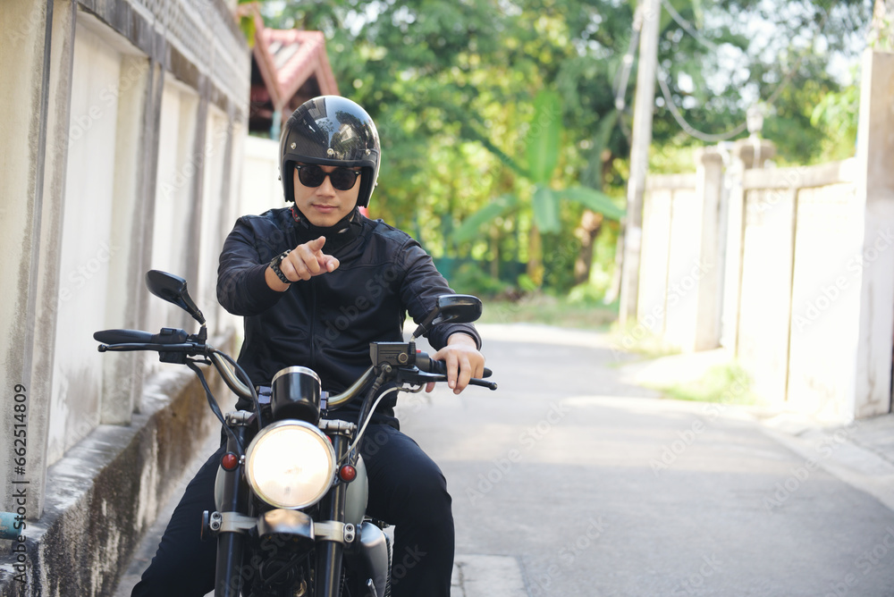 Asian man motorbike in black leather jacket travel rider trip. Handsome Men wear sunglass outdoor lifestyle freedom rider. Men trendy hipster cool person. Young asian man hobby ride with motor bike