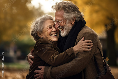 Portrait of an elderly couple together. Happy senior couple in autumn park.