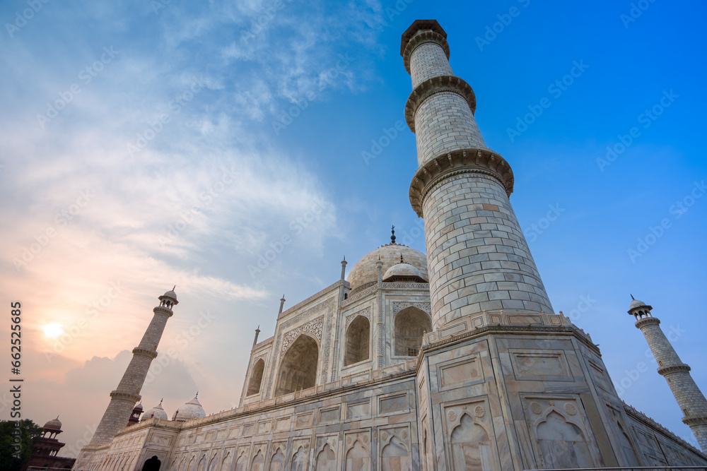 Side view of the Taj Mahal's white domes and white towers at sunset. The Taj Mahal is a treasure of Indian Muslim art. UNESCO World Heritage Site.