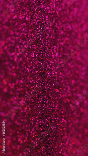 Glitter background. Defocused shimmering. Party sequins. Shiny red festive confetti in abstract bokeh glimmer art. © Photodrive