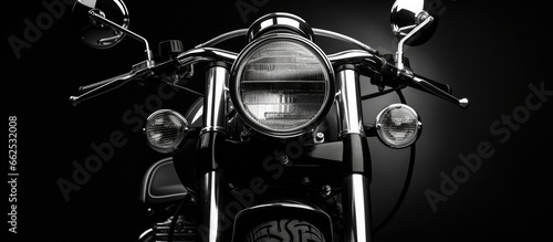 Old style motorcycle with prominent headlight emphasizing black and white hues With copyspace for text