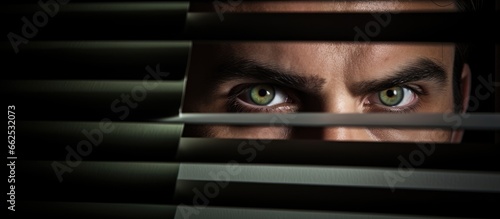 Person peering through blinds