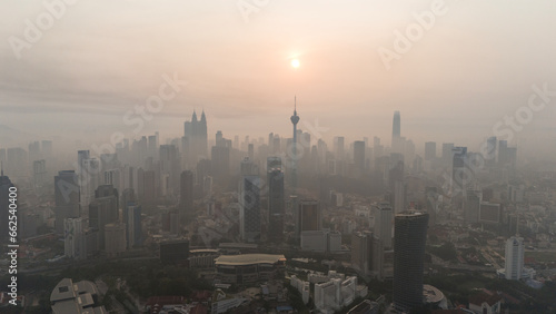 Aerial view of beautiful kuala lumpur cityscape skyline in the hazy or foggy morning enviroment and buildings in silhouette