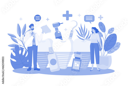 stomatologist doctor explains proper dental hygiene to the patient holding the sample.