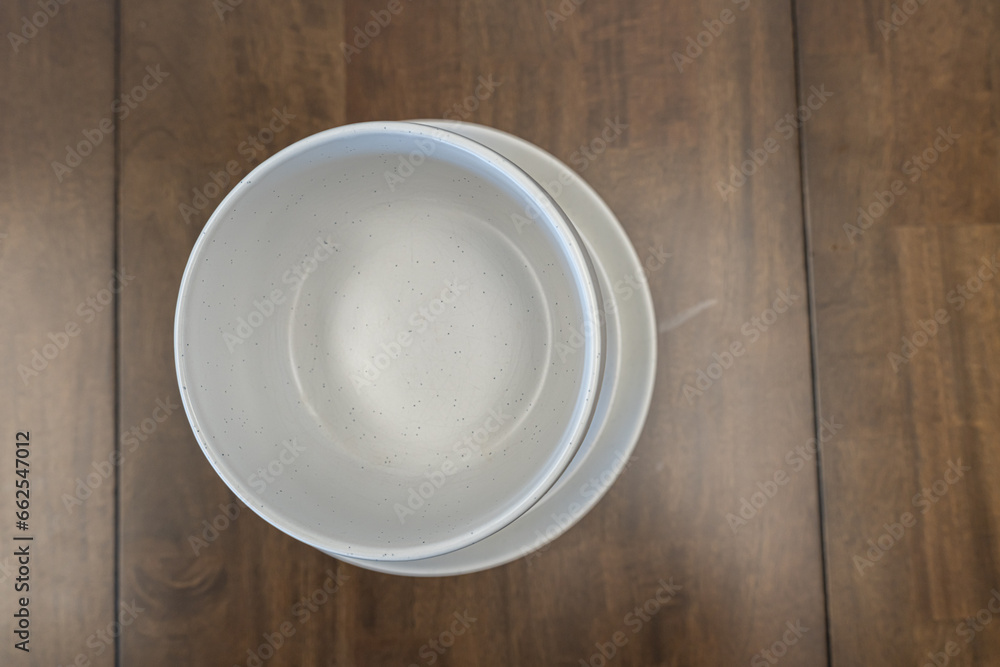 A stack pile of White chinaware on a table A stack pile of White chinaware on a table