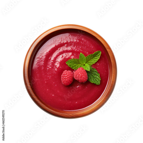 Top view of raspberry coulis dip in a wooden bowl isolated on a white background