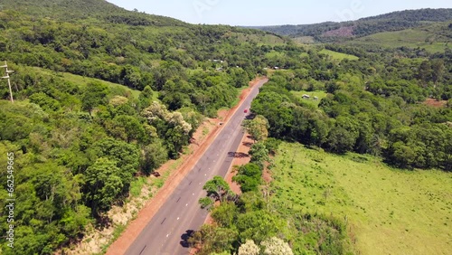 Aerial view captures a pathway in Misiones, Argentina, winding through native woodlands and open fields, illustrating the diverse and scenic landscape of the region.