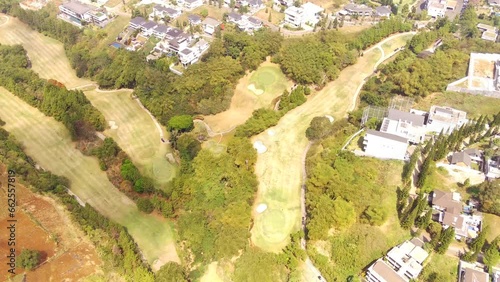 Golf Courses and elite housing. Drone video of a very wide golf course landscape surrounding the elite housing complex, Bojong Koneng - Bandung, Indonesia. Aerial Footage 4k Resolution photo