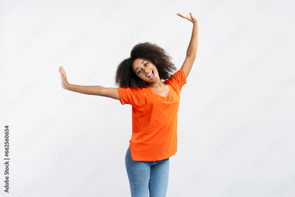 Portrait of smiling authentic African American woman with curly hair wearing orange t shirt Portrait of smiling authentic African American woman with curly hair wearing orange t shirt