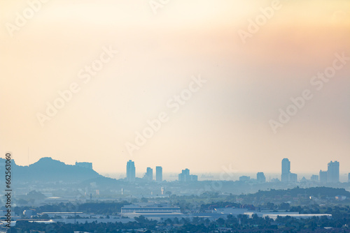 An image the landscape and city architecture urban pm2.5 dust or fog cover there are buildings and forests foreground view.