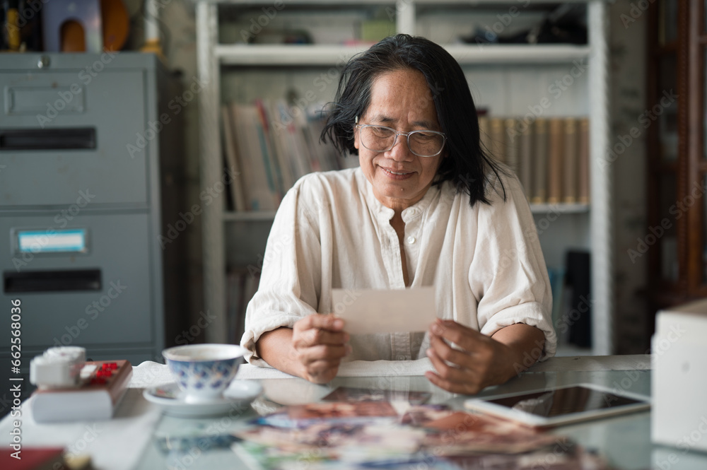 Fototapeta premium old woman looking at old family photographs