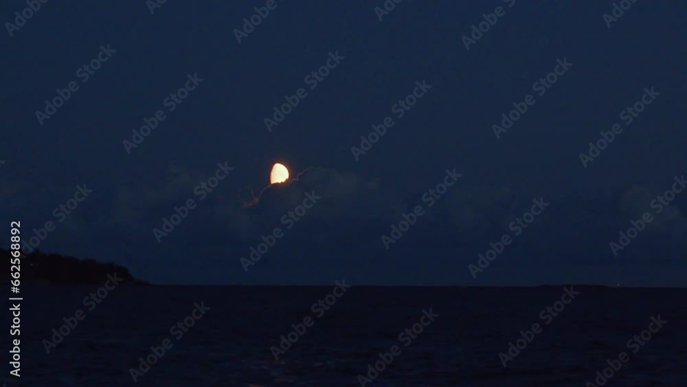 Clouds moving over the moon at night over the sea. Windy bad weather and horror scene. Clouds moving over the moon at night over the sea. Windy bad weather and horror scene.