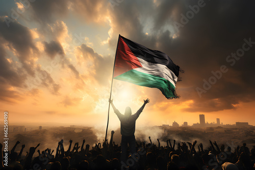 Silhouette of a Palestinian man waving Palestine flag over people. photo
