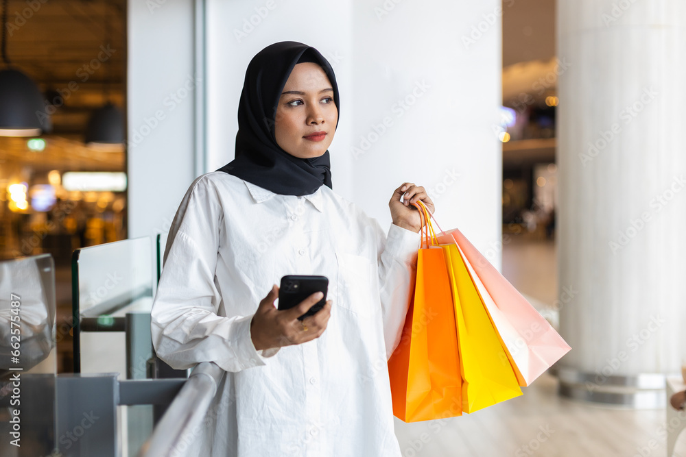 Muslim women wear hijab holding shopping bag color. Female islamic arabic relaxation shopping. fashion lifestyle.