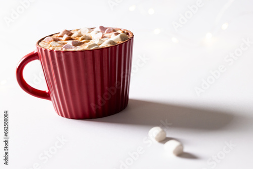 Red christmas mug of chocolate and marshmallows with copy space