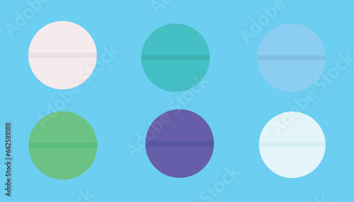 set of colored tablets isolated on light blue background. colorful medicines for health
