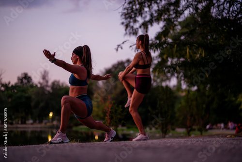 Fit Girls Training Outdoors in a Green Environment at Night