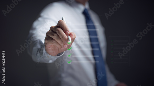 Closeup hand businessman poses filling performance checklist, Digital Online checklist survey, Take an assessment, questionnaire, evaluation, online checklist survey, online exam, comprehensive
