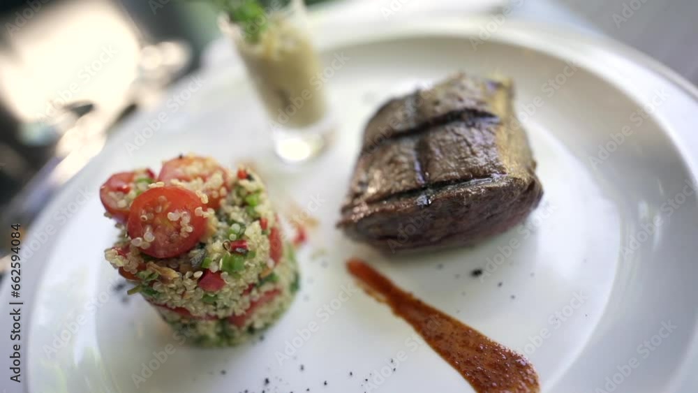 A beautiful dish of lomo steak accompanied by a quinoa salad, a delectable and wholesome combination of flavors and textures. A beautiful dish of lomo steak accompanied by a quinoa salad, a delectable and wholesome combination of flavors and textures.