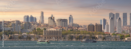 Stunning view of the city of Istanbul, Turkey from across the Bosphorus strait. The image captures the beauty of the city's skyline, with its iconic buildings including Dolmabahce Palace before sunset