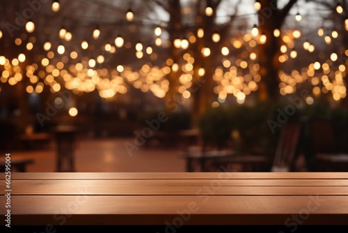 The empty wooden table top with blur background. Gold bokeh