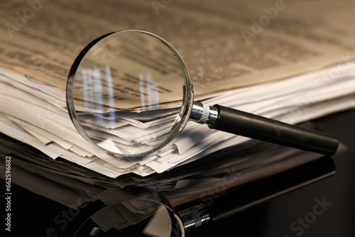 Magnifier and stack of documents