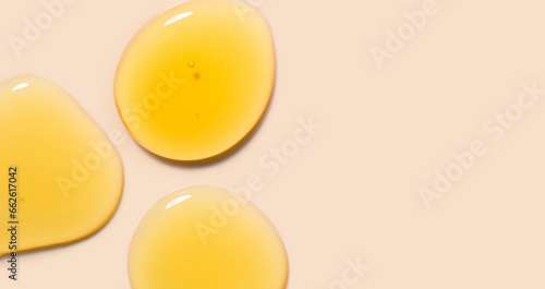 round drops gel serum on beige background
