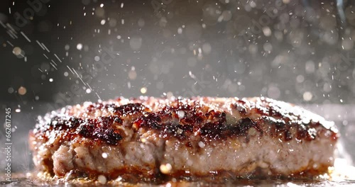 Beef cutlet for halal burger fried in frying pan. Cinematic advertising burger cooking. Well-fried cutlet in frying pan, fragrant steam, splashes of hot bubbling fat. Close-up of delectable cutlets