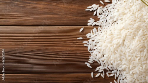top view of White rice with paddy rice ears on a wood background. photo