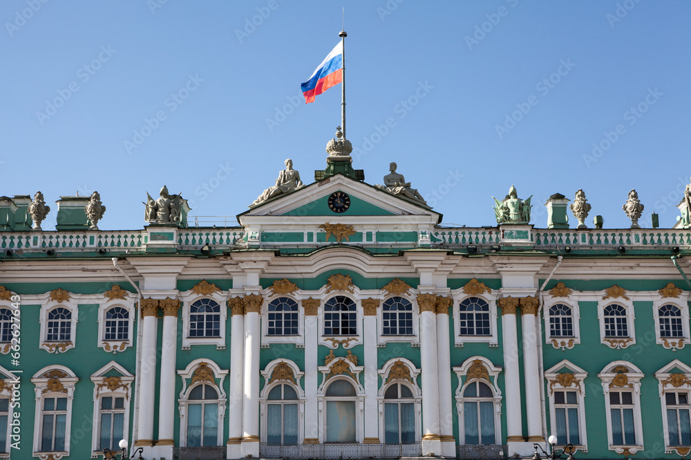 The main facade of the Winter Palace with the Russian flag on the spire. Saint Petersburg