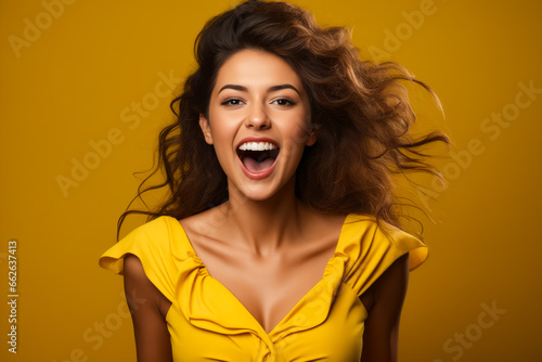 Woman with yellow shirt and yellow background.