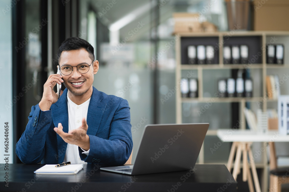 Male businessman talk mobile phones and working on laptop computers, online business, work from home, teleworking concept. Male businessman talk mobile phones and working on laptop computers, online business, work from home, teleworking concept.