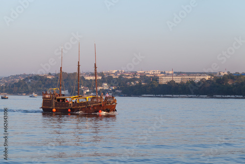 Stylized tourist boat crosses the Sevastopol bay on a summer day