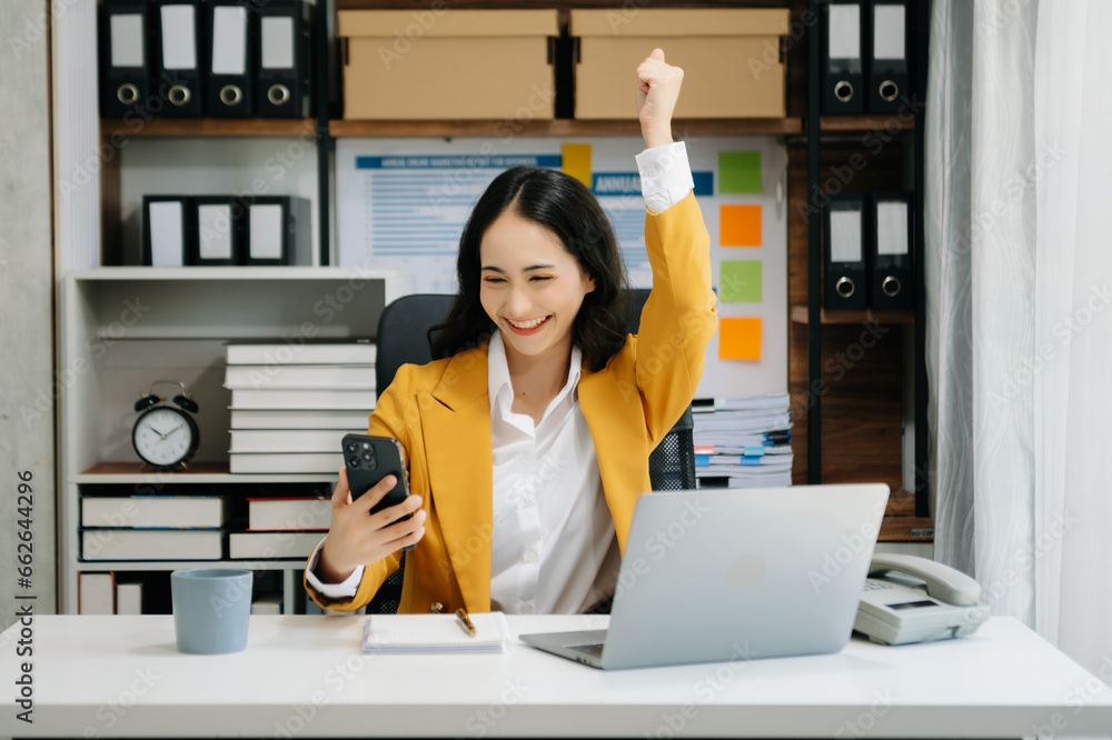Asian business woman are delighted and happy with the work they do on their tablet, laptop and taking notes at the office.. Asian business woman are delighted and happy with the work they do on their tablet, laptop and taking notes at the office..