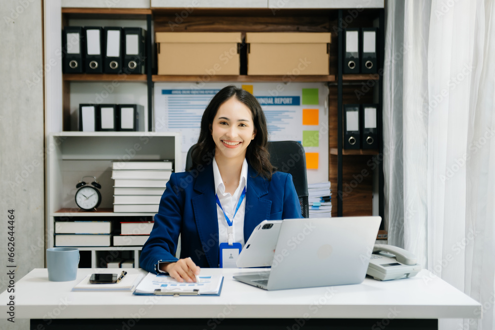 Portrait of female office businesswoman startup daydreaming about her work, startup and working with laptop on office desk in office Portrait of female office businesswoman startup daydreaming about her work, startup and working with laptop on office desk in office