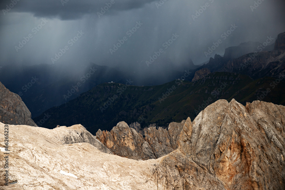 The view of Sassolungo and the Sella Group from Serauta in stormy weather in the Dolomites, Italy.