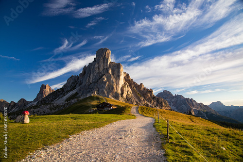 View of Ra Gusela mountain with green meadows and blue sky, Dolomites, Italy © erika8213