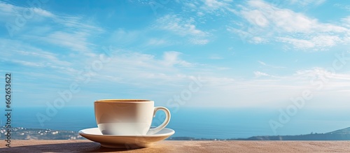 Coffee on balcony against sky With copyspace for text