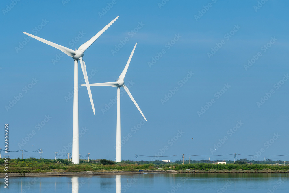 Close-up of wind power systems with the blue sky background.