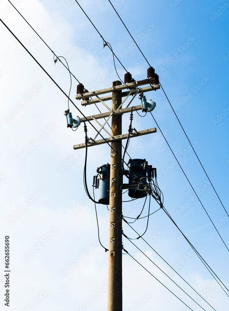 View of utility poles with blue sky and white clouds as a background. View of utility poles with blue sky and white clouds as a background.