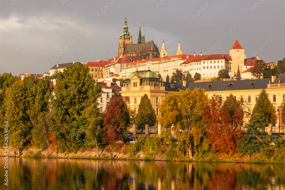 Autumn views from Prague. Picturesque autumn Prague in the morning sun. The Vltava River with the Charles Bridge, the waterfront and houses of Mala Strana and the dominant Prague Castle. Czechia