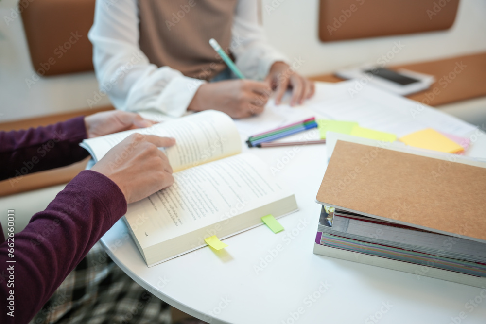 Learning with friends Young students campus.High School Tutor for examining helps school homework together with friend catching up and learning Learning with friends Young students campus.High School Tutor for examining helps school homework together with friend catching up and learning