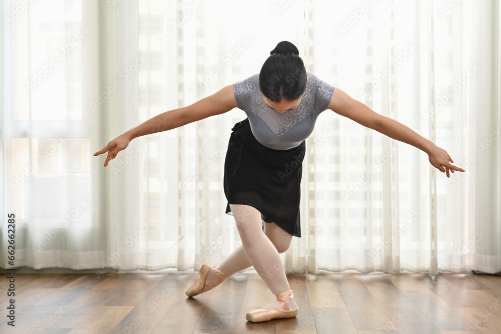 Naklejka premium Pretty young ballerinas practicing ballet positions in studio. Dance, art and active lifestyle concept